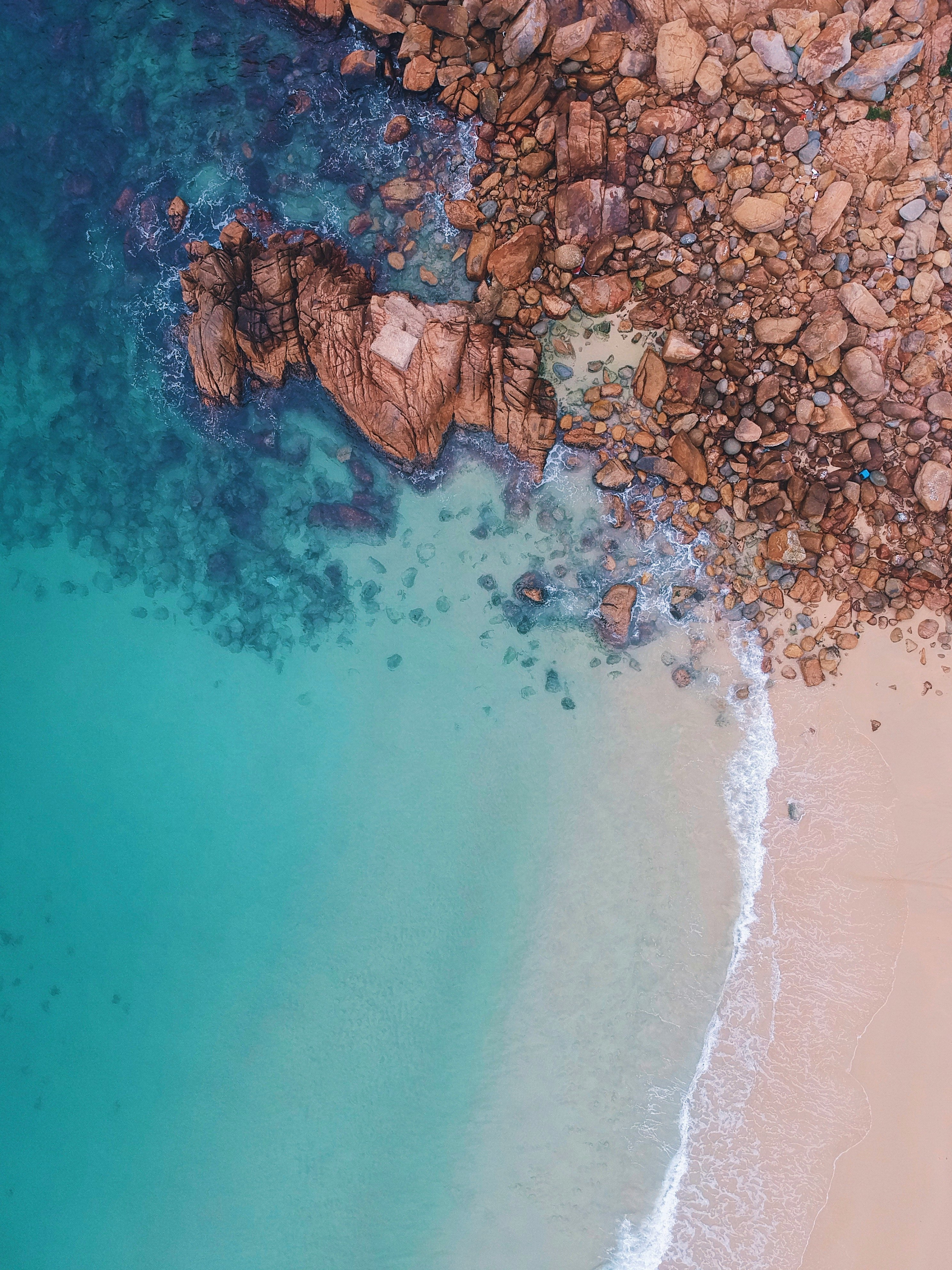 aerial view of rocks near body of water